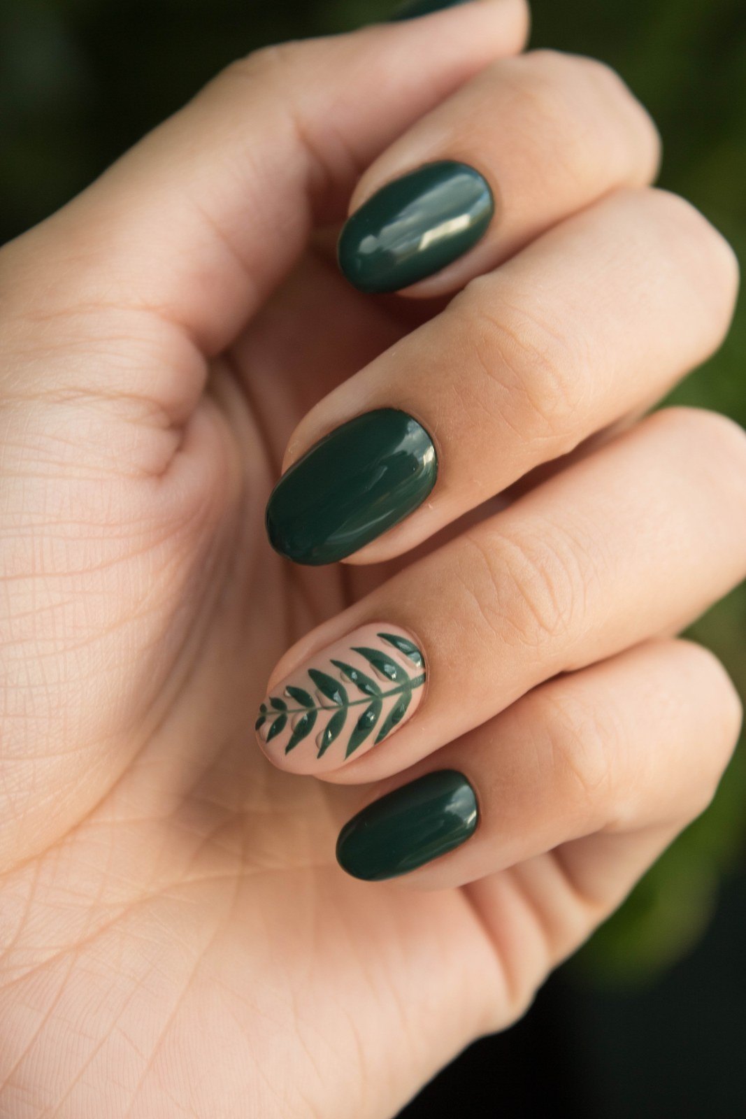 A deep green gel set, the fern on the ring finger painted by hand