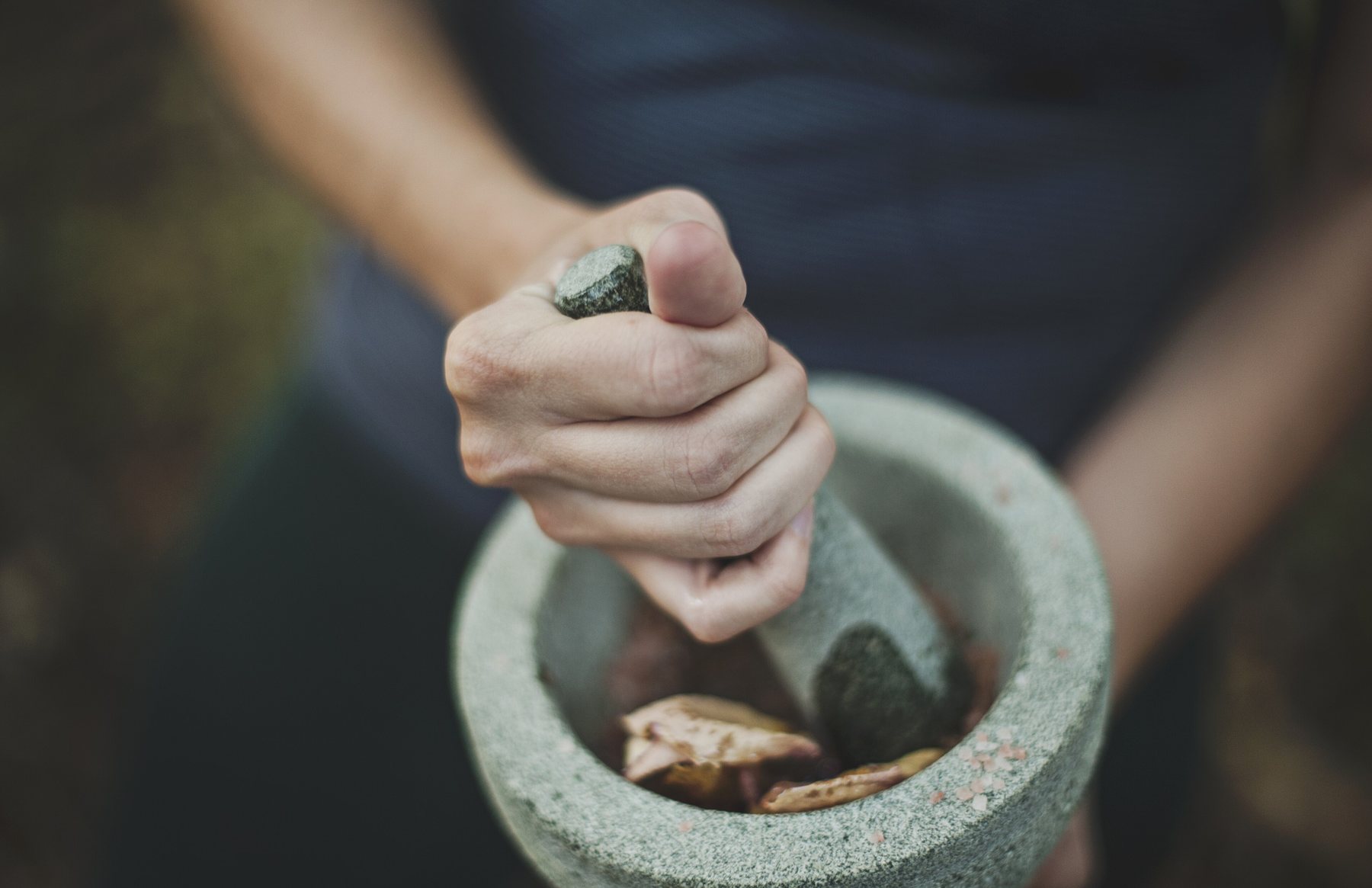 Grinding the arnica and calendula by hand